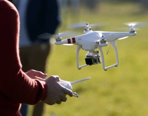 A pilot flies a Phantom drone by DJI company at the 4th Intergalactic Meeting of Phantom's Pilots (MIPP) in an open secure area in the Bois de Boulogne, western Paris, March 16, 2014. Drone operators in France are required to complete a training course to fly an unmanned aerial vehicle and also receive written approval for flights in urban areas. Picture taken March 16, 2014.   REUTERS/Charles Platiau (FRANCE - Tags: SCIENCE TECHNOLOGY)