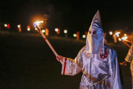 epa05275310 A picture made available on 24 April 2016 shows Pro-white rights organizations the neo-nazi National Socialist Movement and Ku Klux Klan groups participate in a cross and swastika burning in Temple, Georgia, USA, 23 April 2016. The ceremony was held after a day of rallies at Stone Mountain and Rome, Georgia, and to show successful collaboration agreements between the NSM and KKK, two white extremist groups.  EPA/ERIK S. LESSER