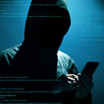 Hacker Hacker using phone at dark