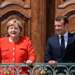 epa06820632 German Chancellor Angela Merkel (L) and French President Emmanuel Macron (R) pose for photos prior to the German-French Ministers Meeting in front of the German government's guesthouse Meseberg Palace in Meseberg, near Berlin, Germany, 19 June 2018. German and French ministers meet for a one day meeting to discuss bilateral topics, including Foreign, Defence and Security politics.  EPA/FILIP SINGER