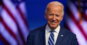 President-elect Joe Biden pauses to smile as listens to media questions at The Queen theater, Tuesday, Nov. 10, 2020, in Wilmington, Del. (AP Photo/Carolyn Kaster)